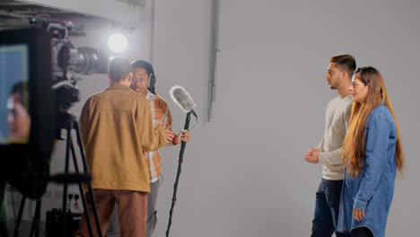 Frustrated-Actors-Shooting-Movie-Or-Video-Scene-In-Studio-as-Sound-Recordist-Drops-Microphone-Into-Shot